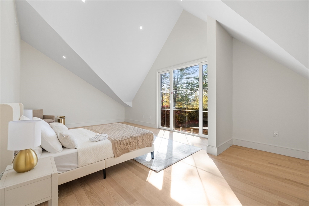 58 Chestnut Street Lynnfield, MA 01940 - Photo 14 of 42 a spacious bedroom with a bed and wooden floor