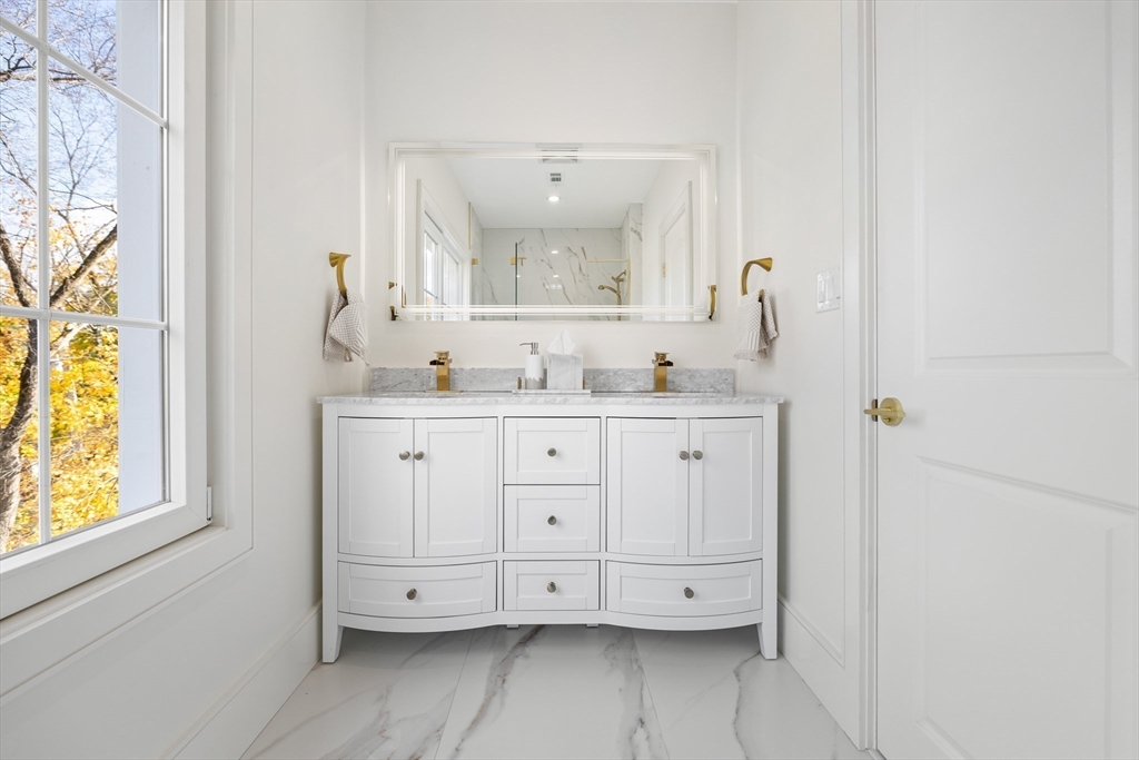 58 Chestnut Street Lynnfield, MA 01940 - Photo 25 of 42 a bathroom with a double vanity sink a mirror and a bathtub