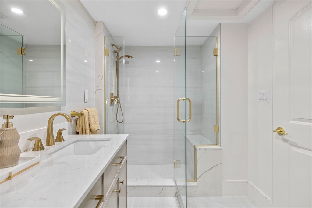 58 Chestnut Street Lynnfield, MA 01940 - Photo 27 of 42 a bathroom with a shower sink and mirror