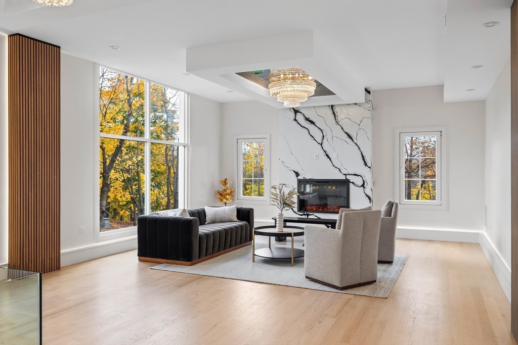 58 Chestnut Street Lynnfield, MA 01940 - Photo 7 of 42 a living room with furniture a fireplace and a flat screen tv