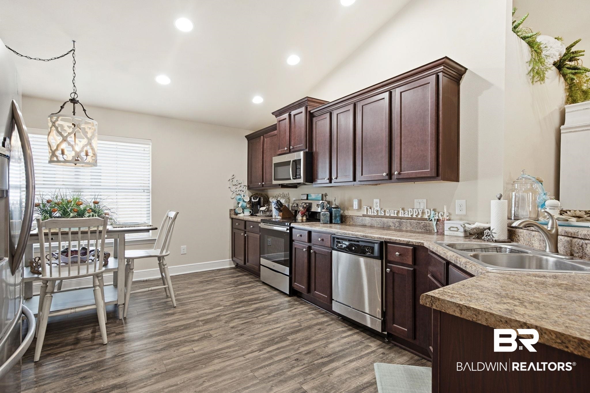 22596 Respite Lane Foley, AL 36535 - Photo 11 of 34 Kitchen with pendant lighting, stainless steel appliances, dark wood finish cabinetry, light countertops, and dark wood finished floors