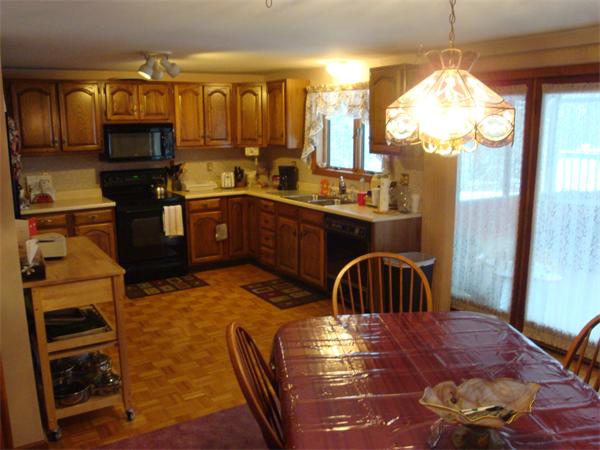 68 Middle Road Amesbury, MA 01913 - Photo 3 of 15 a kitchen with a refrigerator and a stove