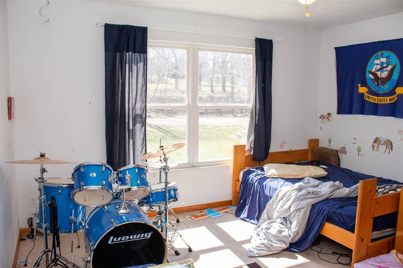 426 Lockwood Road Davis, IL 61019 - Photo 14 of 25 a bedroom with two beds and a window
