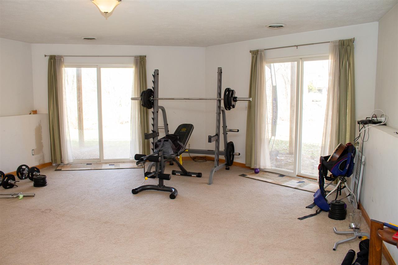 426 Lockwood Road Davis, IL 61019 - Photo 18 of 25 a view of a room with gym equipment and a large window