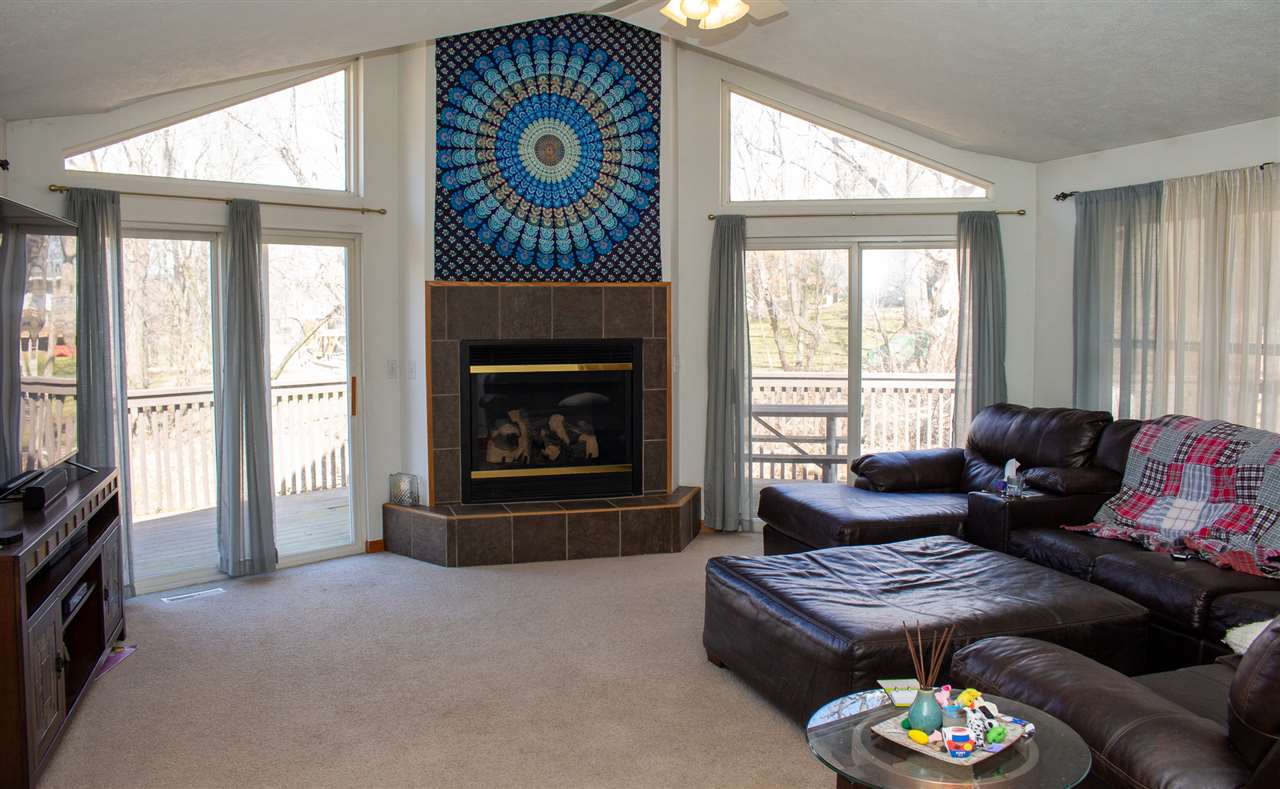 426 Lockwood Road Davis, IL 61019 - Photo 4 of 25 a living room with furniture a fireplace and a large window