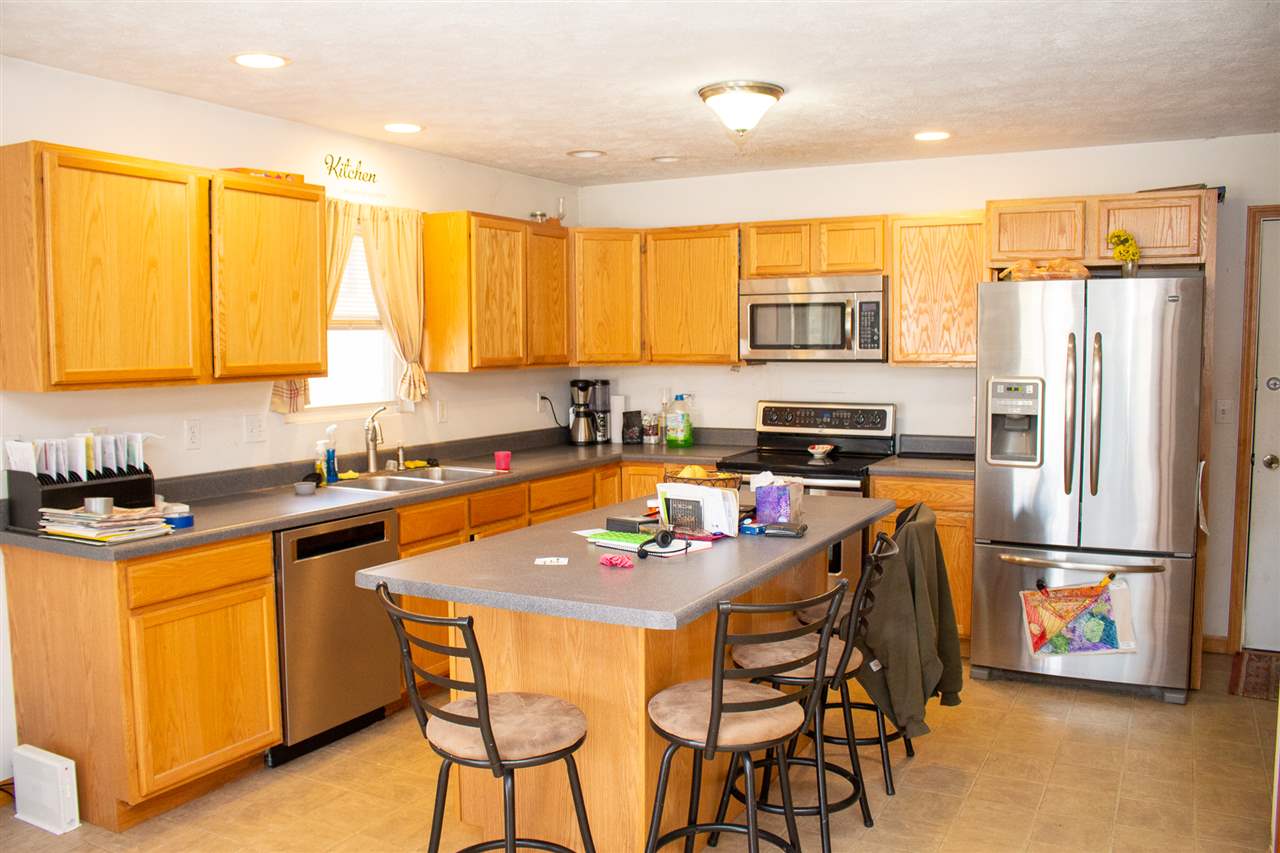 426 Lockwood Road Davis, IL 61019 - Photo 7 of 25 a kitchen with stainless steel appliances granite countertop a stove top oven a refrigerator a sink and a microwave