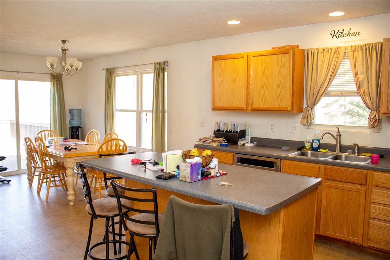 426 Lockwood Road Davis, IL 61019 - Photo 8 of 25 a kitchen with a table chairs stove and cabinets