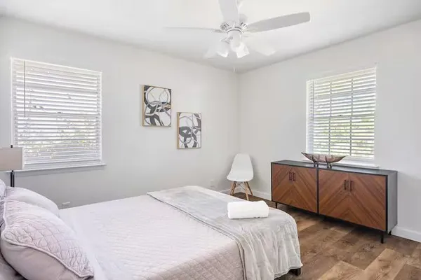 a bedroom with a large bed and a window