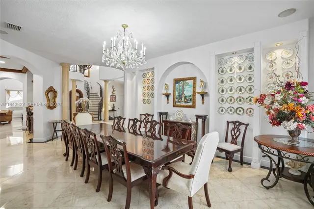 a front view of a house with a yard and fountain