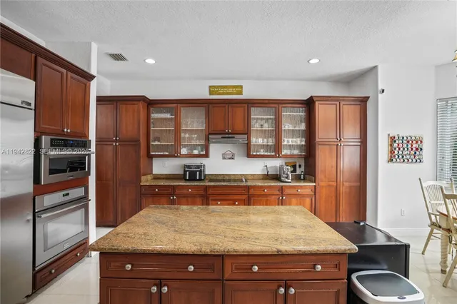 a living room with fireplace furniture and a chandelier