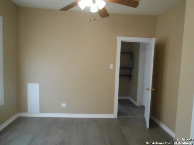 an empty room with a empty space and a ceiling fan