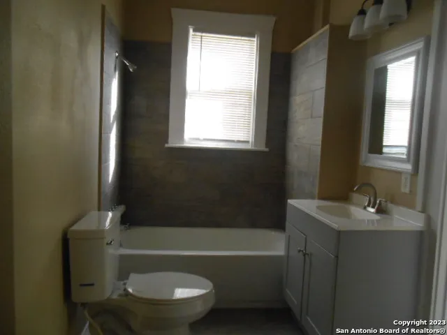 a bathroom with a sink toilet and bathtub