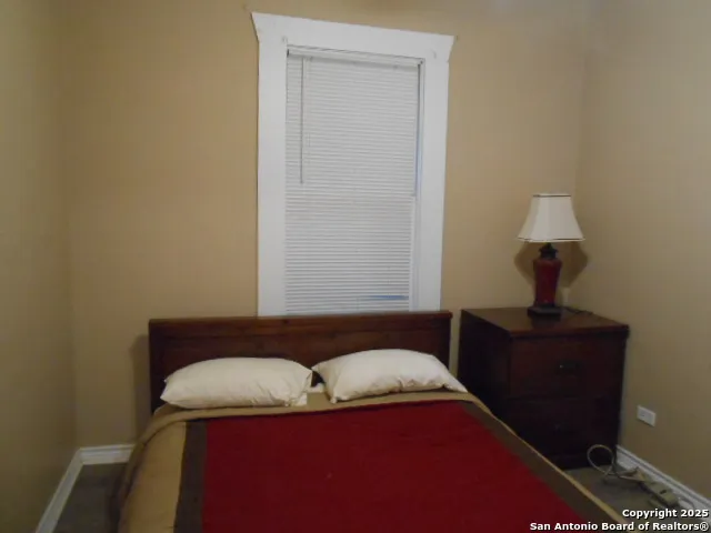 a living room with furniture and a lamp