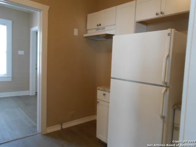 a white refrigerator freezer sitting in a kitchen