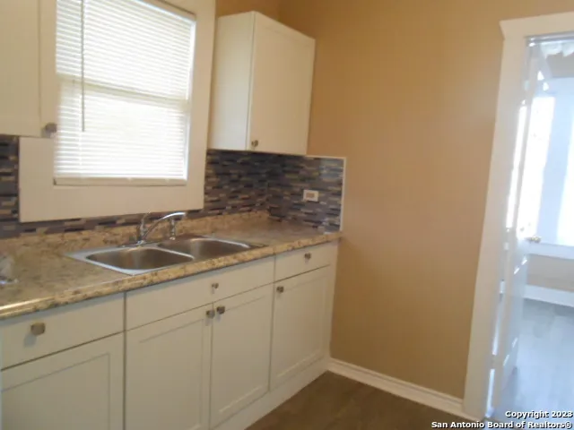 a bathroom with a sink and a window