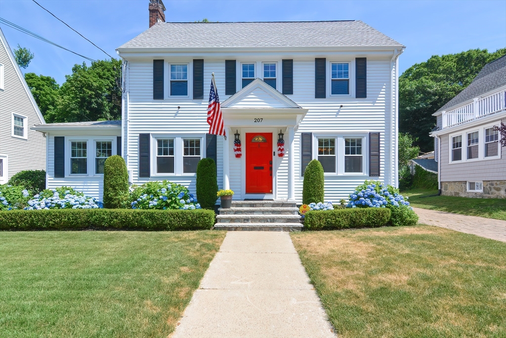 a front view of a house with garden