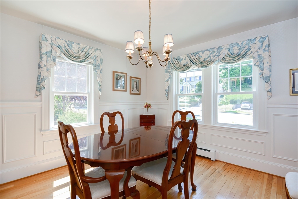 207 Lawrence Road Medford, MA 02155 - Photo 15 of 42 a dining room with furniture a chandelier and wooden floor