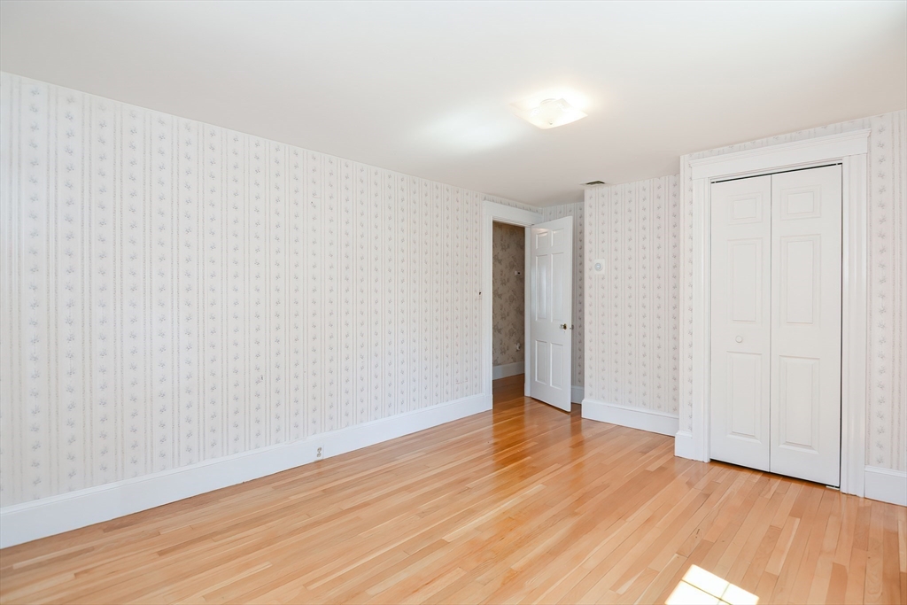 207 Lawrence Road Medford, MA 02155 - Photo 34 of 42 a view of an empty room with wooden floor