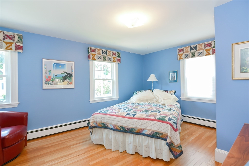 207 Lawrence Road Medford, MA 02155 - Photo 36 of 42 a bedroom with a bed and wooden floor