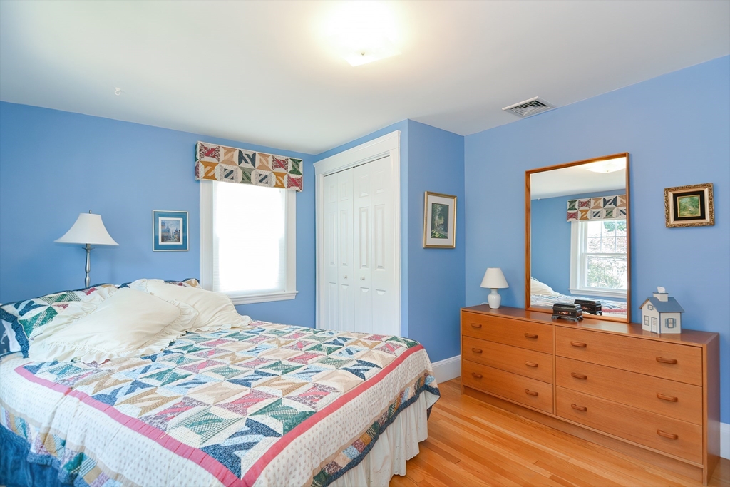 207 Lawrence Road Medford, MA 02155 - Photo 37 of 42 a bedroom with a bed and a dresser in it