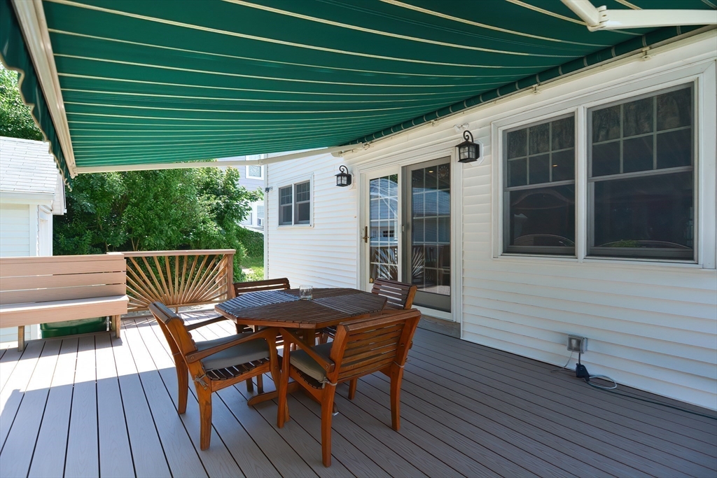 207 Lawrence Road Medford, MA 02155 - Photo 40 of 42 a view of a deck that has a table and chairs with wooden floor