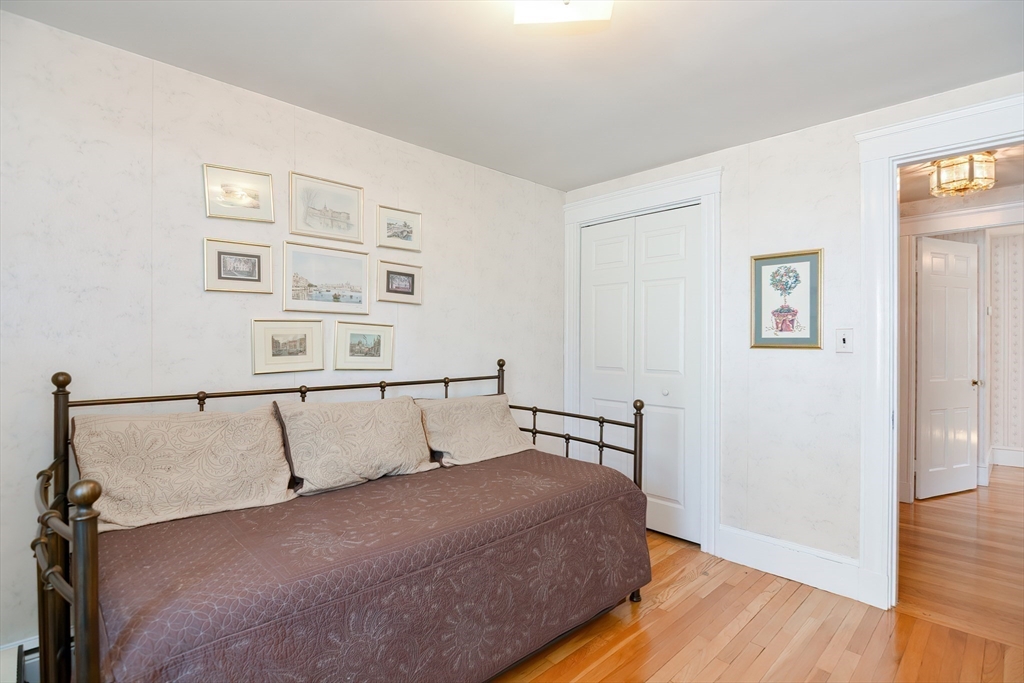 207 Lawrence Road Medford, MA 02155 - Photo 41 of 42 a bedroom with a bed and wooden floor
