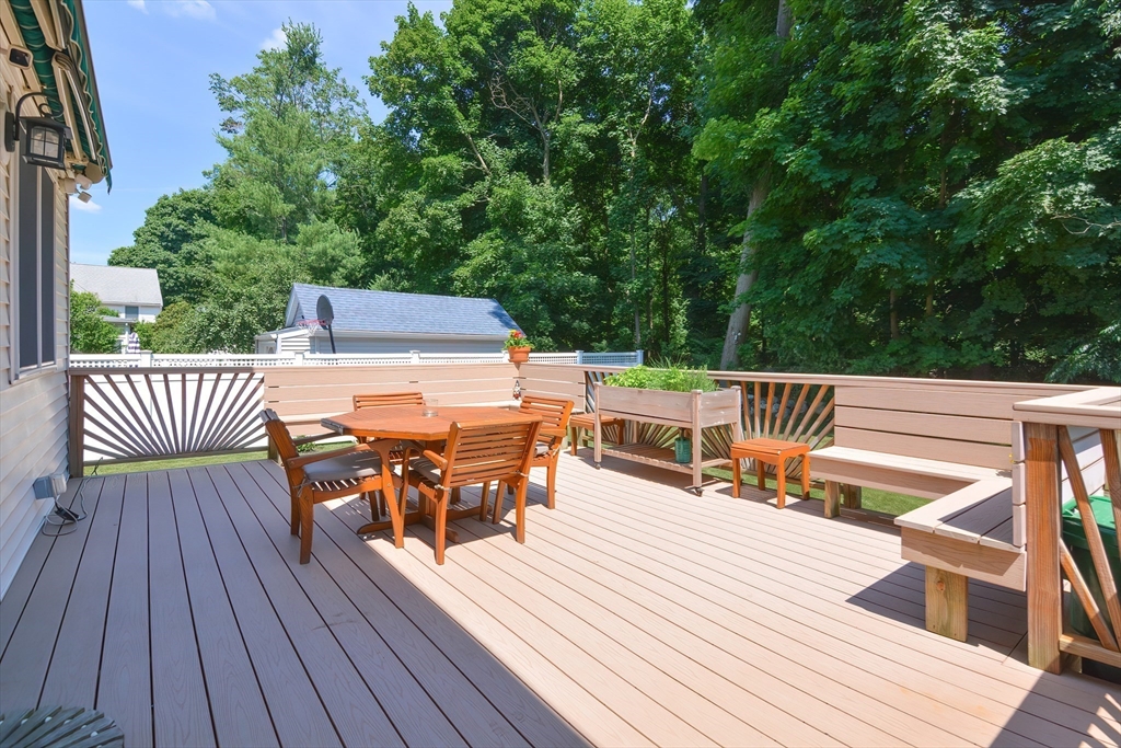 207 Lawrence Road Medford, MA 02155 - Photo 7 of 42 a view of a roof deck with table and chairs wooden floor and fence