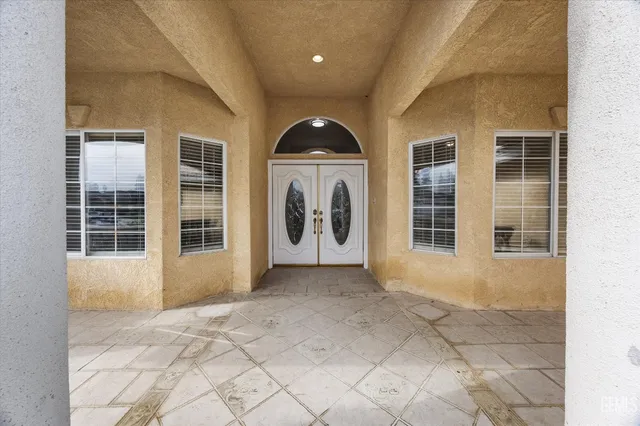 a view of a house with a rug and a yard