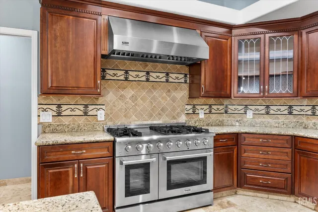 a kitchen with stainless steel appliances granite countertop a stove and a sink