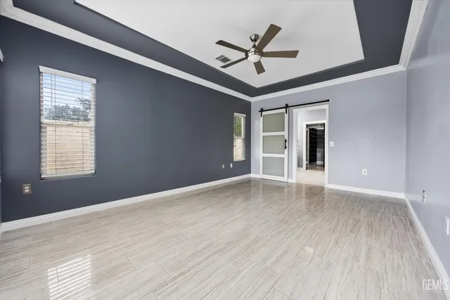 a view of a livingroom with a ceiling fan and window