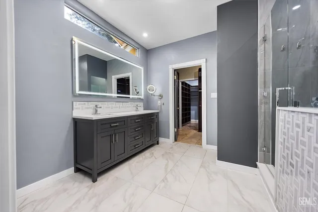 a spacious bathroom with a granite countertop sink mirror and toilet