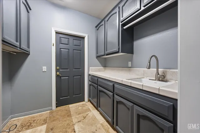 a kitchen with a sink and cabinets