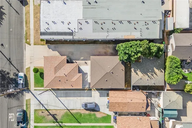 an aerial view of a residential building with outdoor space and seating area
