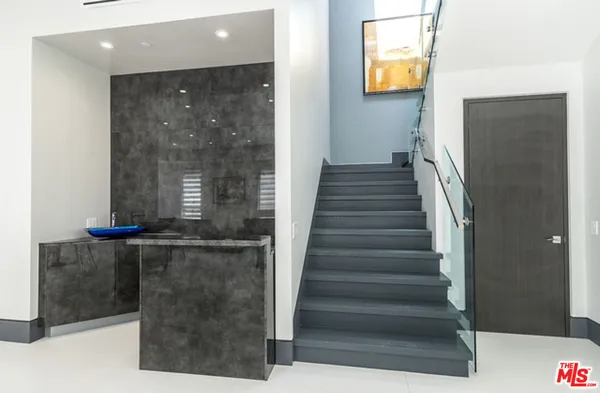 a bedroom with a large bed and a large window