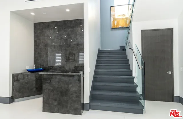 a bedroom with a large bed and a large window