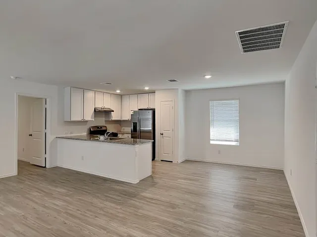 a kitchen with stainless steel appliances a refrigerator sink and cabinets