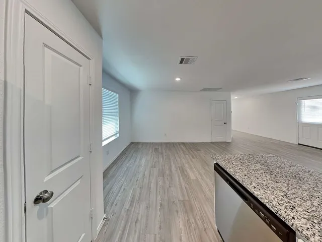 a view of hallway with wooden floor
