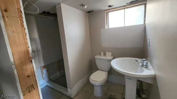 a white toilet sitting next to a bathroom sink