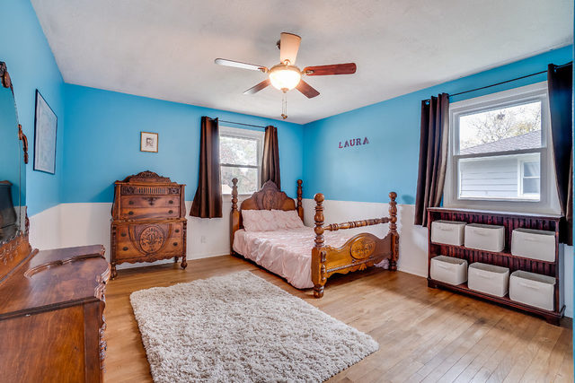 59 Neil Road Sugar Grove, IL 60554 - Photo 14 of 22 a bedroom with a bed a dresser and wooden floor