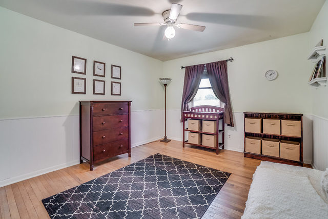 59 Neil Road Sugar Grove, IL 60554 - Photo 15 of 22 a bedroom with a bed and a dresser