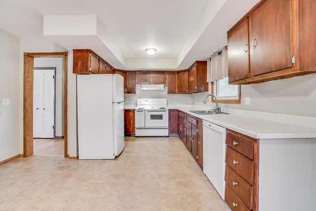 59 Neil Road Sugar Grove, IL 60554 - Photo 6 of 22 a kitchen with a sink a refrigerator and cabinets