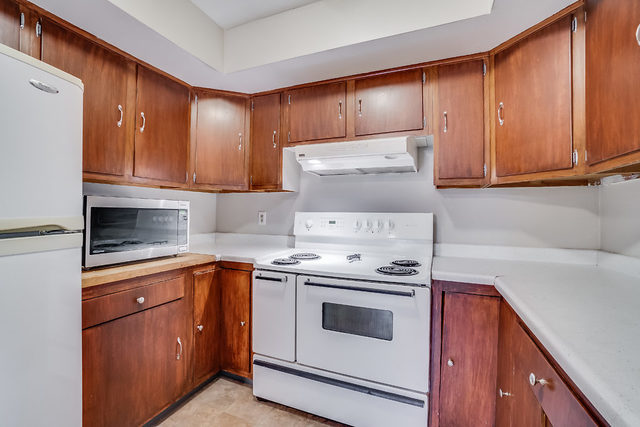 59 Neil Road Sugar Grove, IL 60554 - Photo 7 of 22 a kitchen with a stove top oven sink and cabinets