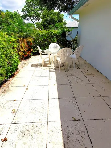 a view of a yard and front a palm tree