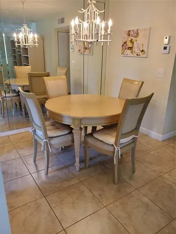 a view of a dining room with furniture and chandelier