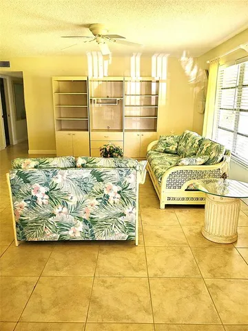 a spacious bedroom with a bed and a night stand