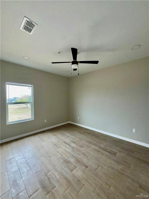 716 Ragland Road, Unit 8 Mission, TX 78572 - Photo 10 of 19 wooden floor in an empty room