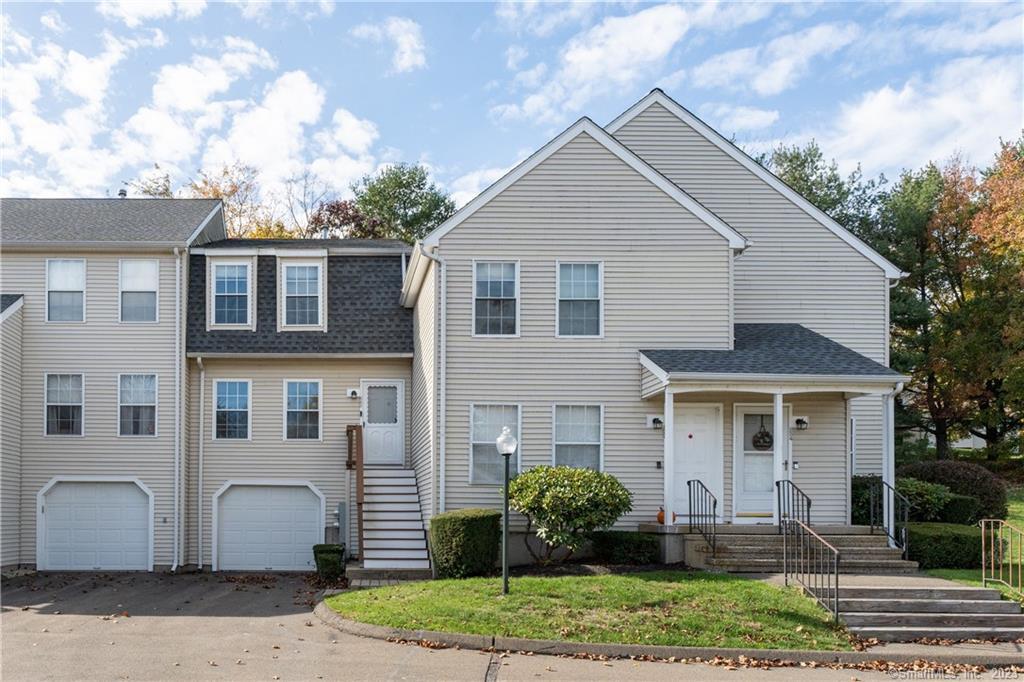 229 Branford Road, Unit 235 North Branford, CT 06471 - Photo 1 of 1 a front view of a house with a yard and porch