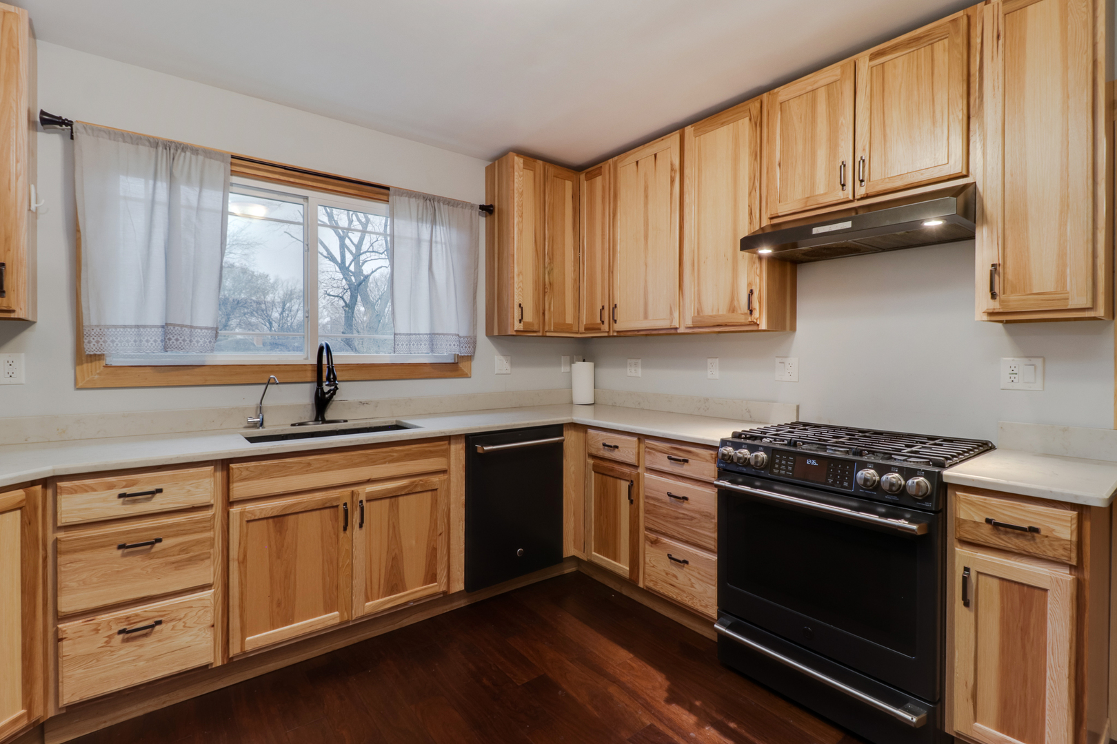 900 Beech Street Normal, IL 61761 - Photo 21 of 36 a kitchen with granite countertop wooden cabinets stainless steel appliances and a window