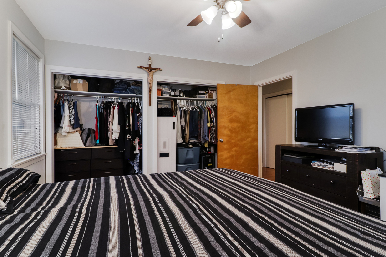 900 Beech Street Normal, IL 61761 - Photo 25 of 36 a bedroom with wooden floor bed and a chandelier