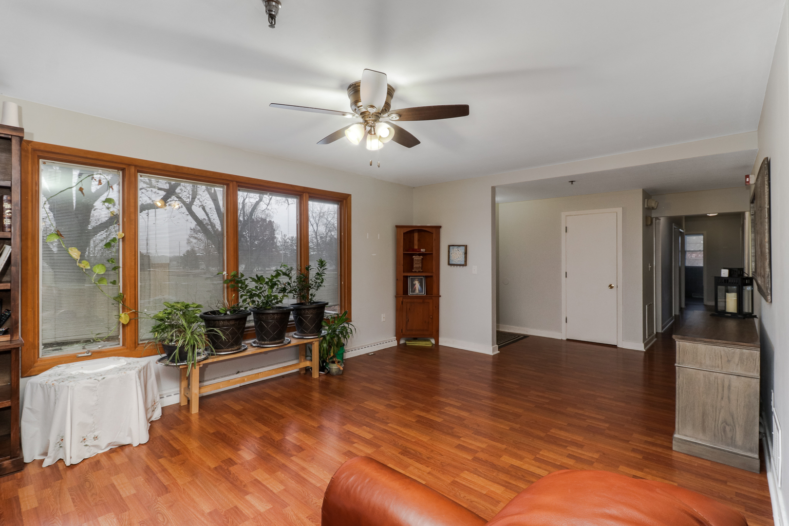 900 Beech Street Normal, IL 61761 - Photo 28 of 36 a view of an empty room with window ceiling fan and wooden floor